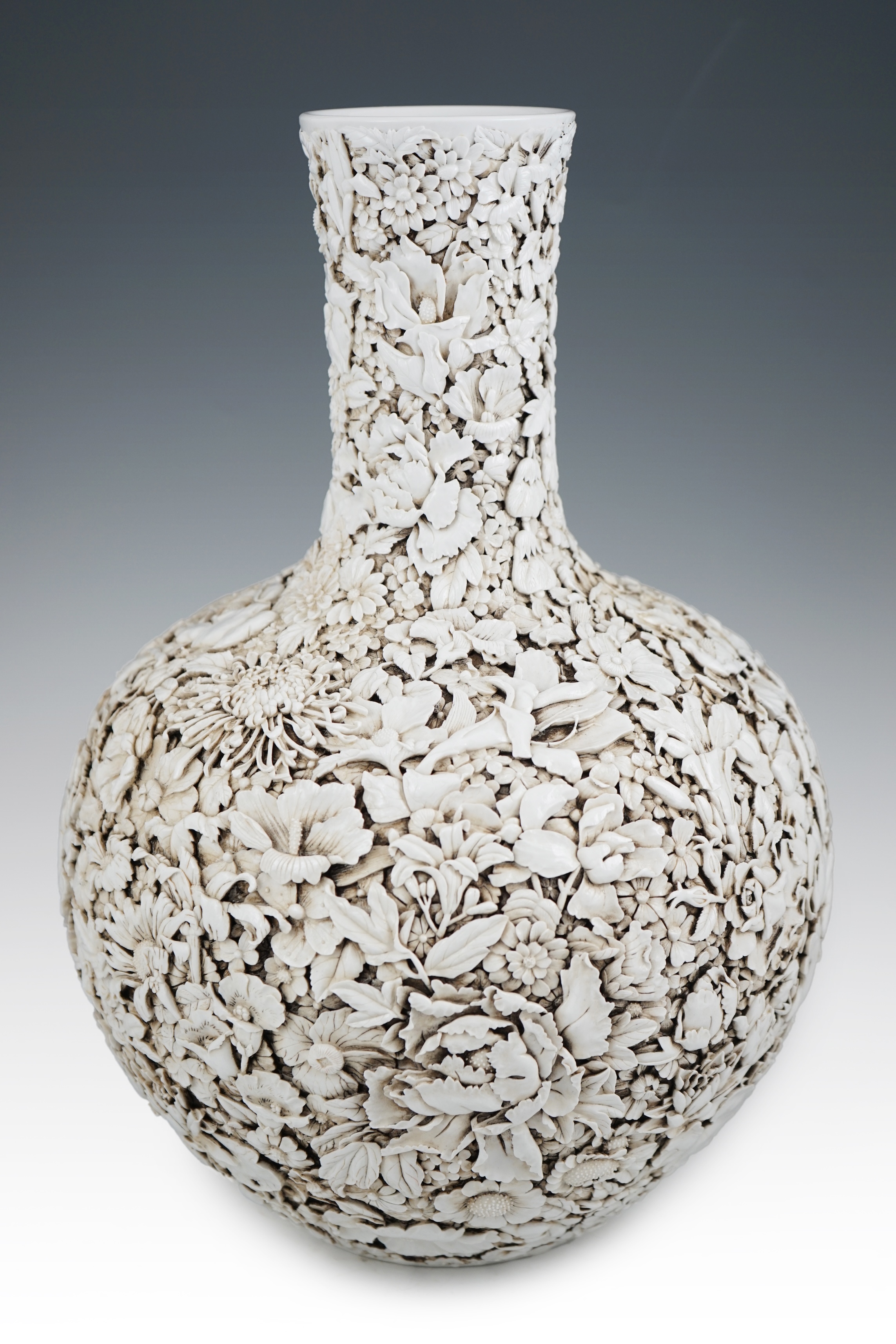 A large Chinese carved porcelain ‘thousand flower’ bottle vase, 20th century